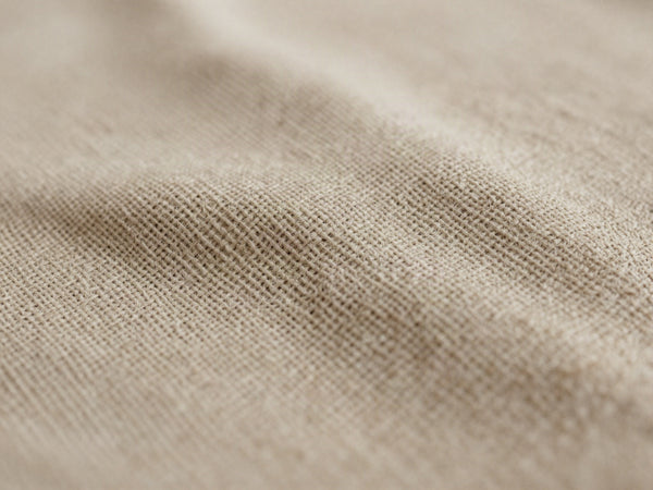Makronärbild av beige vävt tyg med linnelook